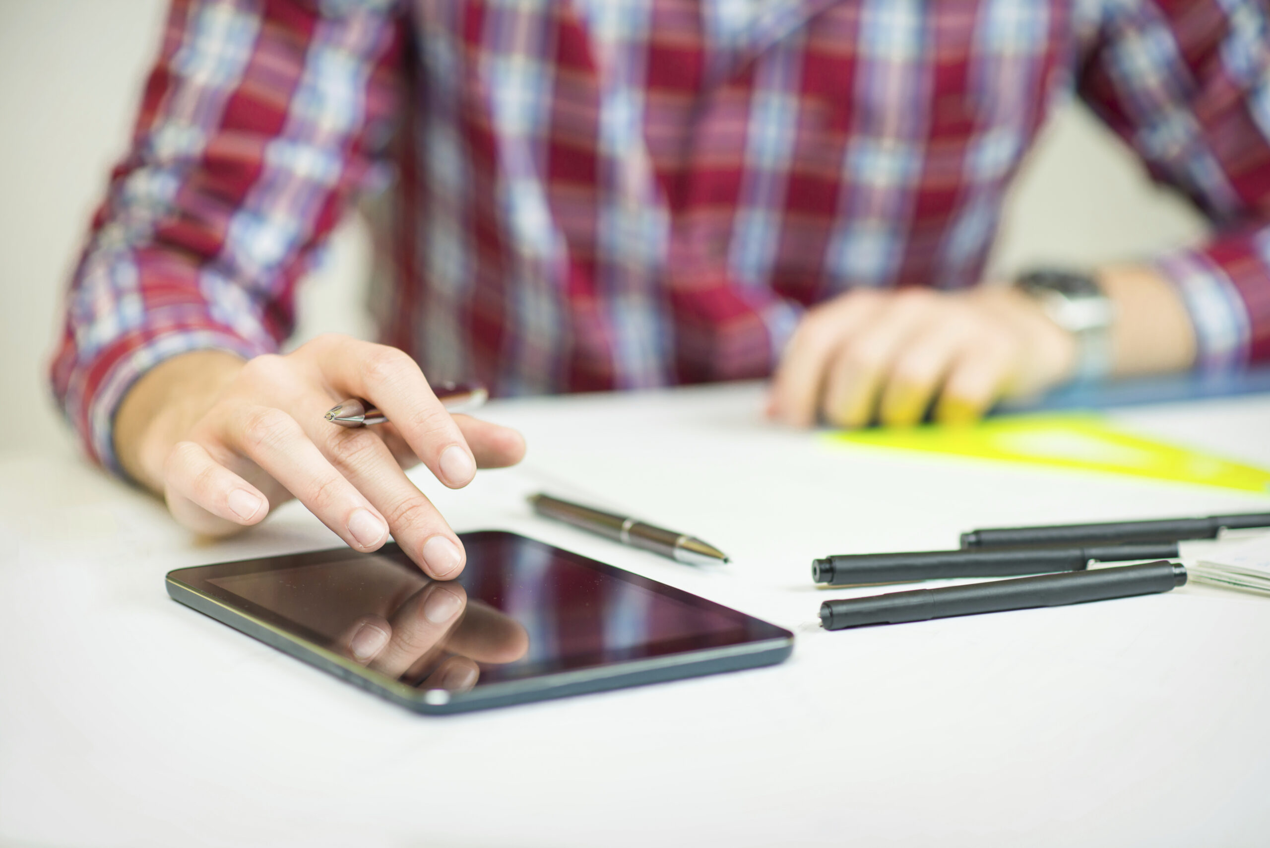 Man on iPad Looking at Content Writing